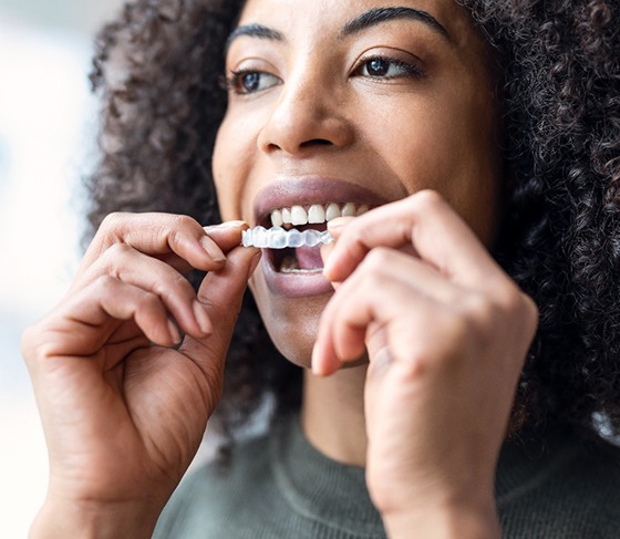 Woman inserting a clear aligner