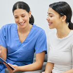 Female patient discussing payment options with staff member 