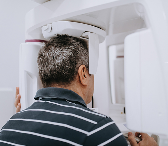 Man having mouth scanned with cone beam scanner