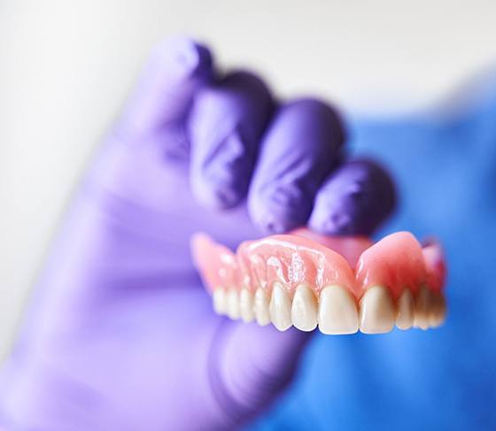 Three older women smiling and laughing together