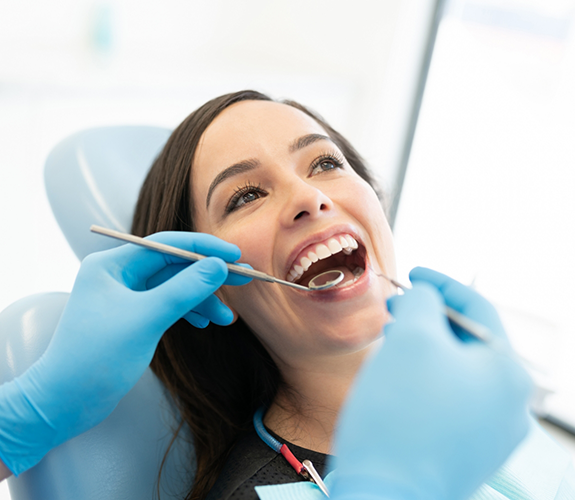 Female patient having teeth examined during dental checkup