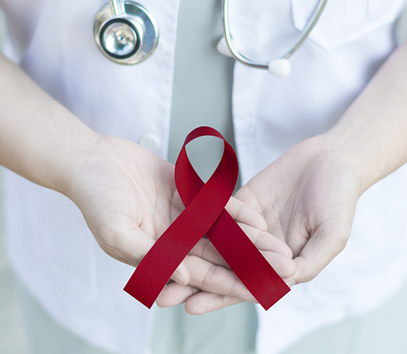 Holding a ribbon for oral cancer awareness