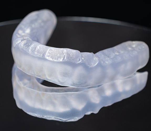 Clear aligner on black reflective surface