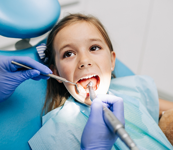 Little girl having her teeth cleaned