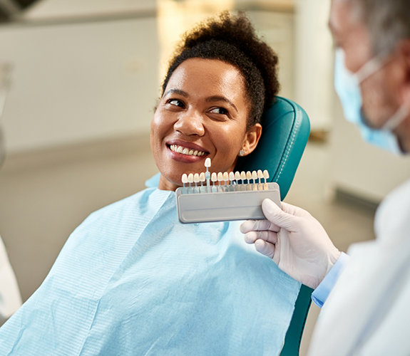 Female dental patient having teeth shade matched for cosmetic dentistry in Frankfort