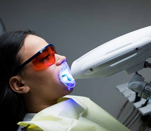 Female patient receiving teeth whitening treatment