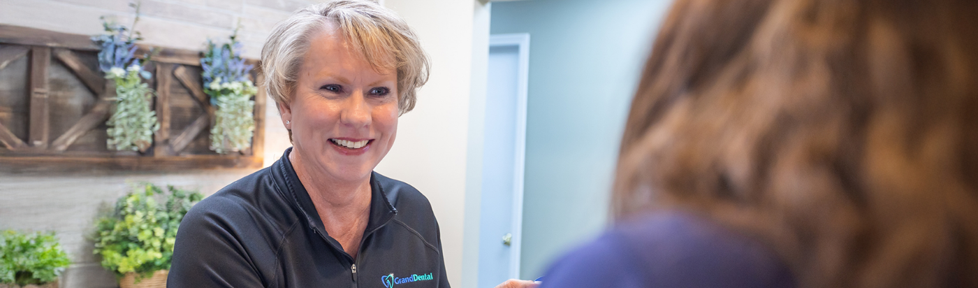Front desk team member greeting patient