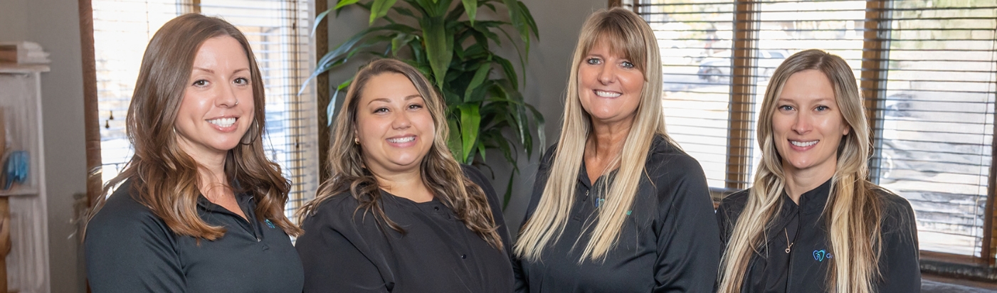 Four smiling dental team members at Grand Dental Frankfort