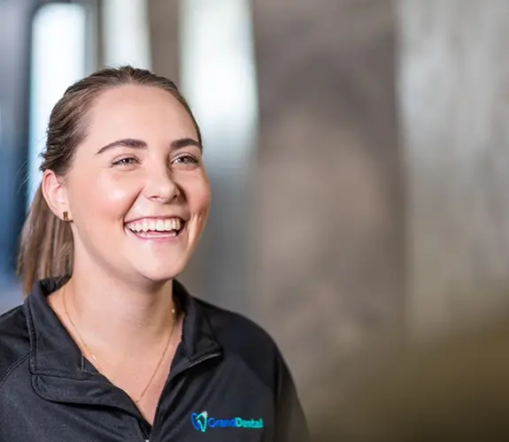 Dentist and patient shaking hands over desk
