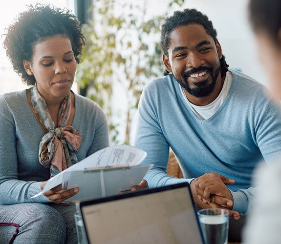 Couple discussing insurance with a dentist