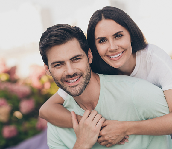 Man giving woman a piggyback ride