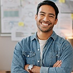 Young man in a denim shirt showing off his smile