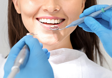 Female patient having teeth examined
