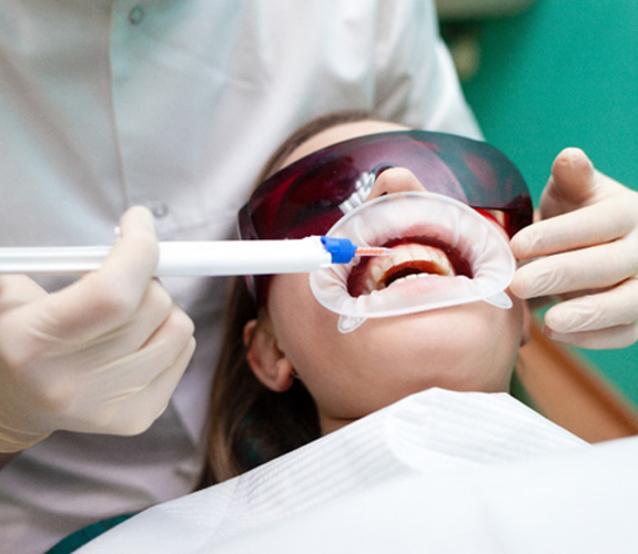Patient receiving in-office teeth whitening 