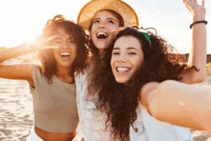 Group of friends smiling on the beach