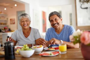 Older couple smiling with healthy teeth and gums